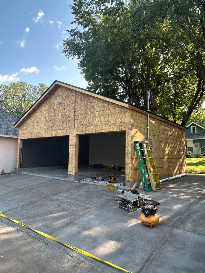 Two door car garage being prepped for siding installation